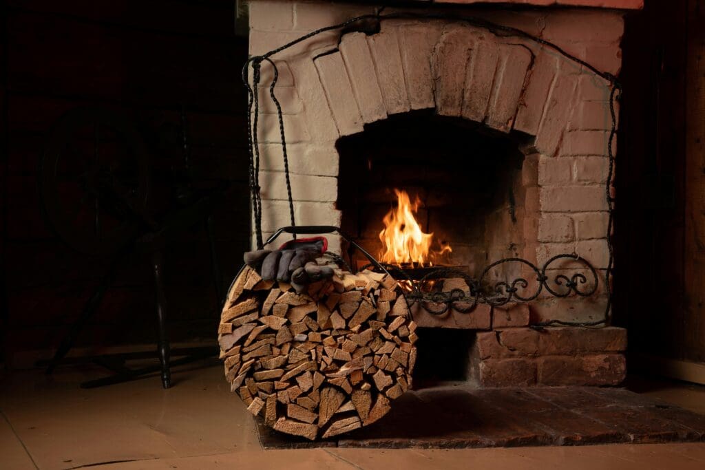 A warm fireplace with a stack of firewood evokes comfort and relaxation.