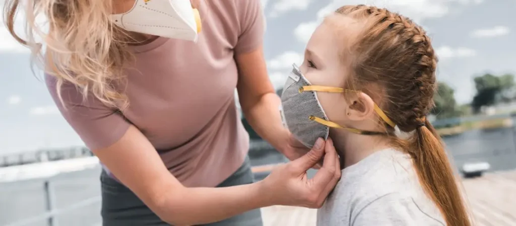 An adult and a child wearing respirators